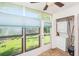 Enclosed patio with view of the backyard and stacked washer and dryer at 13710 Mission Oaks Blvd # 2A, Seminole, FL 33776