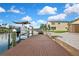 Backyard view from dock, featuring the boatlifts, canal access and landscaped yard at 13814 Lavender Ave, Hudson, FL 34667
