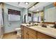 Well-appointed bathroom with double sinks, a large mirror and decorative accents at 13814 Lavender Ave, Hudson, FL 34667