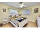 Bright bedroom with ceiling fan, natural light, and stylish decor at 13814 Lavender Ave, Hudson, FL 34667