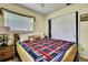 Comfortable bedroom with tile flooring, bright windows, and closet at 13814 Lavender Ave, Hudson, FL 34667