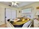 Well-lit bedroom with a ceiling fan, tile floors and ample closet space at 13814 Lavender Ave, Hudson, FL 34667