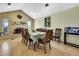 Cozy dining area featuring a brick fireplace, elegant furnishings, and plenty of natural light at 13814 Lavender Ave, Hudson, FL 34667