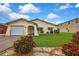 Charming single-story home featuring a well-manicured lawn and colorful landscaping at 13814 Lavender Ave, Hudson, FL 34667