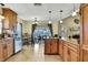 Modern kitchen with stainless steel dishwasher, wood cabinets and a breakfast nook with patio access at 13814 Lavender Ave, Hudson, FL 34667