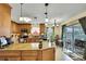 Well-equipped kitchen with wooden cabinets, granite countertops, and modern appliances at 13814 Lavender Ave, Hudson, FL 34667