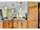 Open kitchen showcasing a view of the dining area with granite countertops and wood cabinets at 13814 Lavender Ave, Hudson, FL 34667