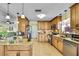 Bright eat-in kitchen with stainless steel appliances and a center island with granite countertops at 13814 Lavender Ave, Hudson, FL 34667