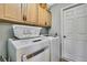 Functional laundry area with modern washer and dryer, cabinets, and storage options at 13814 Lavender Ave, Hudson, FL 34667