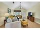 Inviting living room with a vaulted ceiling, cozy seating, and a warm, welcoming ambiance at 13814 Lavender Ave, Hudson, FL 34667