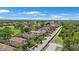 Overhead view of residential homes along a tree-lined street near a golf course at 1391 Marinella Dr, Palm Harbor, FL 34683