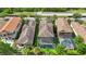 Birds eye view of a home with a screened pool and view of neighboring properties at 1391 Marinella Dr, Palm Harbor, FL 34683