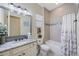 Well-lit bathroom features a granite countertop, soaking tub, and elegant tile details at 1391 Marinella Dr, Palm Harbor, FL 34683