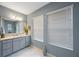 Neutral tones accent this bathroom with a large mirror and great natural light at 1391 Marinella Dr, Palm Harbor, FL 34683