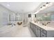 Elegant bathroom featuring dual vanities, soaking tub, and glass-enclosed shower at 1391 Marinella Dr, Palm Harbor, FL 34683