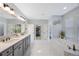 Spacious bathroom with dual sinks, soaking tub, and ample natural light at 1391 Marinella Dr, Palm Harbor, FL 34683