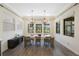Dining room with modern lighting and a rustic table at 1391 Marinella Dr, Palm Harbor, FL 34683