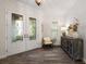 Elegant foyer with glass front doors, wood floors, and stylish decor at 1391 Marinella Dr, Palm Harbor, FL 34683
