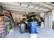 A well-organized garage interior with shelving, storage containers, ladders, and a variety of equipment at 1391 Marinella Dr, Palm Harbor, FL 34683