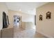Spacious hallway with decorative wall decor and light-colored tile flooring at 1391 Marinella Dr, Palm Harbor, FL 34683