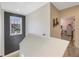 Upstairs hallway with a modern faux-brick accent wall and natural light from window at 1391 Marinella Dr, Palm Harbor, FL 34683