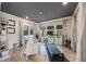 Bright home office with modern desk, treadmill, built-in shelving, and lots of natural light at 1391 Marinella Dr, Palm Harbor, FL 34683