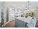 Well-appointed kitchen showcasing white cabinets, a gray island, stainless appliances, and modern pendant lighting at 1391 Marinella Dr, Palm Harbor, FL 34683