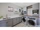 Well-organized laundry room with built-in storage and modern appliances at 1391 Marinella Dr, Palm Harbor, FL 34683