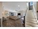 Open-concept living space with a staircase and a large entertainment area at 1391 Marinella Dr, Palm Harbor, FL 34683