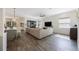 Open-concept living room with wood floors, shiplap accent wall, and modern furnishings at 1391 Marinella Dr, Palm Harbor, FL 34683