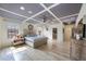 Bright main bedroom with tray ceiling, fan, light wood floors, and walk-in closet at 1391 Marinella Dr, Palm Harbor, FL 34683