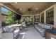 Covered patio with stylish furniture and television at 1391 Marinella Dr, Palm Harbor, FL 34683