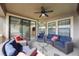 Covered patio with stylish furniture and views into the home at 1391 Marinella Dr, Palm Harbor, FL 34683