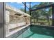 The outdoor pool features a rock waterfall feature, perfect for relaxation and ambiance at 1391 Marinella Dr, Palm Harbor, FL 34683