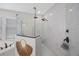 Modern walk-in shower featuring rainfall shower head and marble tile surround at 1391 Marinella Dr, Palm Harbor, FL 34683