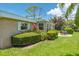 Charming home featuring an inviting backyard with lush greenery, a patio, and outdoor dining set at 1510 Palmer Ct, Palm Harbor, FL 34685