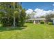 Expansive backyard with lush lawn and mature trees creating a private outdoor space at 1510 Palmer Ct, Palm Harbor, FL 34685