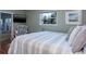 Comfortable bedroom with a metal frame bed and light green colored walls and a TV at 1510 Palmer Ct, Palm Harbor, FL 34685