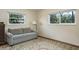 Cozy room with a comfortable couch, natural light from two windows, and a decorative rug on wood floors at 1510 Palmer Ct, Palm Harbor, FL 34685