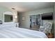 Relaxing bedroom with a metal frame bed, a sliding glass door, and lots of natural light at 1510 Palmer Ct, Palm Harbor, FL 34685