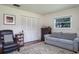 Inviting bedroom featuring neutral decor, a comfortable couch, closet and a decorative area rug at 1510 Palmer Ct, Palm Harbor, FL 34685