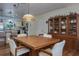 Dining room with stylish light fixture, adjacent to the updated kitchen at 1510 Palmer Ct, Palm Harbor, FL 34685
