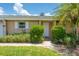 Charming villa entrance surrounded by lush landscaping at 1510 Palmer Ct, Palm Harbor, FL 34685