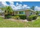 Charming villa featuring a well-manicured lawn and lush landscaping at 1510 Palmer Ct, Palm Harbor, FL 34685