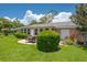 Spacious backyard with a patio, lush lawn, and mature landscaping around the home at 1510 Palmer Ct, Palm Harbor, FL 34685