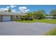 Charming villa featuring a well-manicured lawn, an attached garage and lush landscaping at 1510 Palmer Ct, Palm Harbor, FL 34685