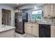 Well-lit kitchen featuring stainless steel refrigerator and wood-look flooring at 1510 Palmer Ct, Palm Harbor, FL 34685