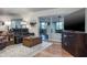 Relaxing living room features a leather sofa set, wood accents, and a large sliding door at 1510 Palmer Ct, Palm Harbor, FL 34685