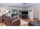 Open living area with a leather recliner, a mounted TV, and lots of natural light at 1510 Palmer Ct, Palm Harbor, FL 34685