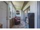 Cozy sunroom featuring brick accent wall, tile floors, natural light, and seating area at 1510 Palmer Ct, Palm Harbor, FL 34685